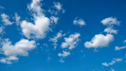 Fototapeta na wymiar Little cumulus clouds on a blue sky. Background.