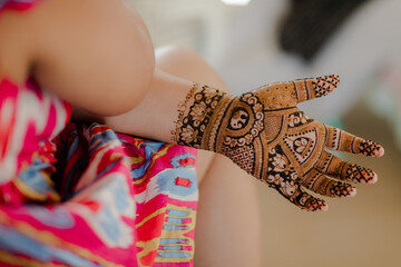 Artist applying henna tattoo on women hands. Mehndi is traditional Indian decorative art.