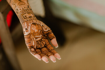 Artist applying henna tattoo on women hands. Mehndi is traditional Indian decorative art.