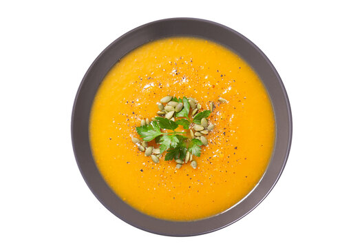 plate of pumpkin soup with parsley isolated on transparent background,  top view