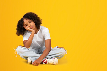 Obraz premium Sad tired bored adolescent african american girl in white t-shirt sit on floor, wants to sleep