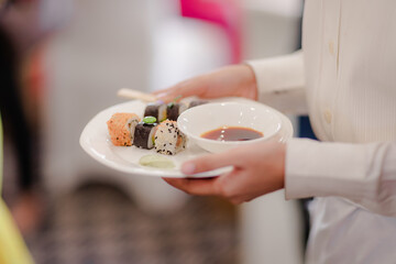 hand holding sushi