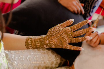 Artist applying henna tattoo on women hands. Mehndi is traditional Indian decorative art. Close-up