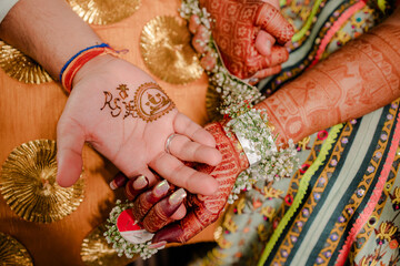 Artist applying henna tattoo on women hands. Mehndi is traditional Indian decorative art. Close-up