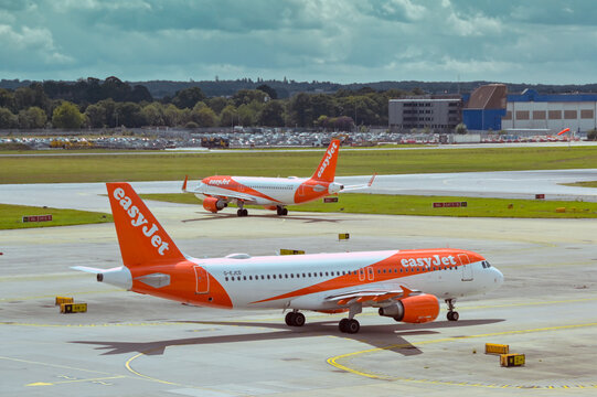 London, England, UK - 1 August 2023: Airbus A320 jet operated by budget airline easyjet (registration G-EJCD) taxiing to take off at London Gatwick Airport. In the background is another easyjet plane.