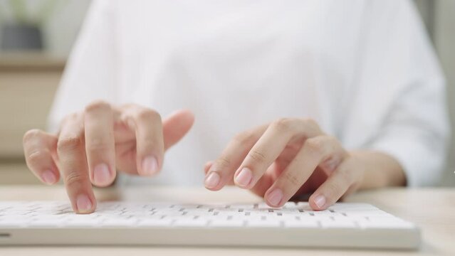 close up hand of a business woman typing keyboard with hands and fingers desktop computer on desk office,online messaging and online marketing business concept.