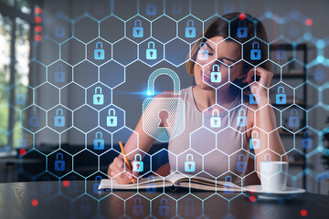 Smiling woman in casual wear taking notes in notebook at office workplace with coffee cup. Concept of distant business education, information technology, dreaming, thinking. Lock drawings