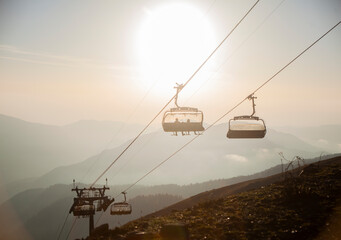 Open cabins of a chairlift in the mountains