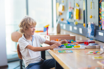 Child with educational toys in school