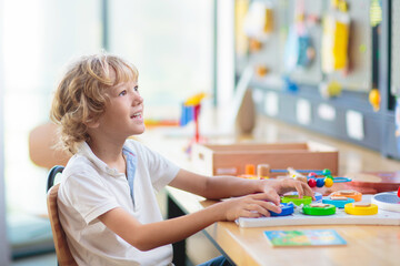 Child with educational toys in school