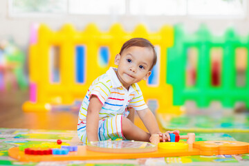Cute baby boy in kindergarten or daycare.