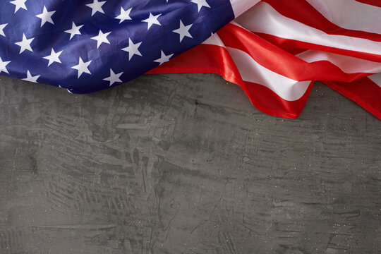 Infusing the Labor Day experience with patriotic fervor. Top view photo of national USA flag on concrete grey background with empty space for promo or text