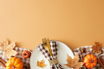 Autumnal charm brought to the table. Top view shot of plate, cutlery, napkin, tablecloth, pumpkins,...