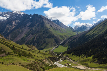 Kyrgyzstan gorges. Colourful travel background. Beautiful scenic view. Mountain green valley landscape. Barskoon gorge with river, mountains and forest