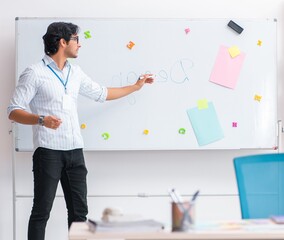 Fototapeta premium Young handsome male designer working in the office