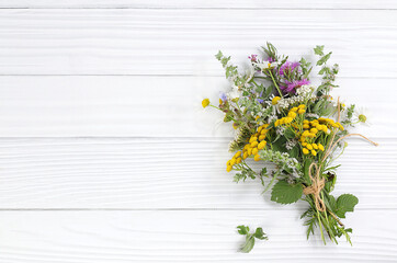 Floral arrangement of wild herbs and flowers , autumn background, Bouquet of tansy, mint, celandine, chamomile and yarrow, collection of useful herbs for treatment according to folk recipes.