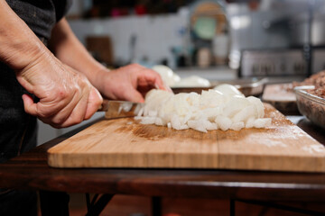 Top view Close up of unrecognizable latin woman chopping onion and meat for filling chilean baked empanadas
