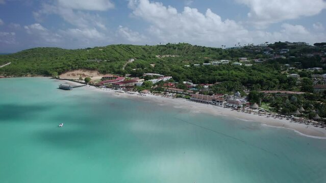 The drone aerial footage of Dickenson Bay beach, Antigua Island. Dickenson Bay is on the Northwestern coast of Antigua and is the most developed beach on the island.