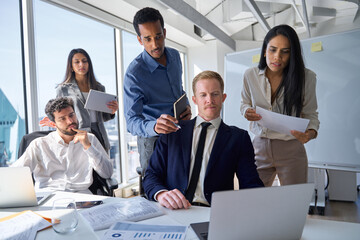 Busy diverse professional business people board executives looking at laptop in office....