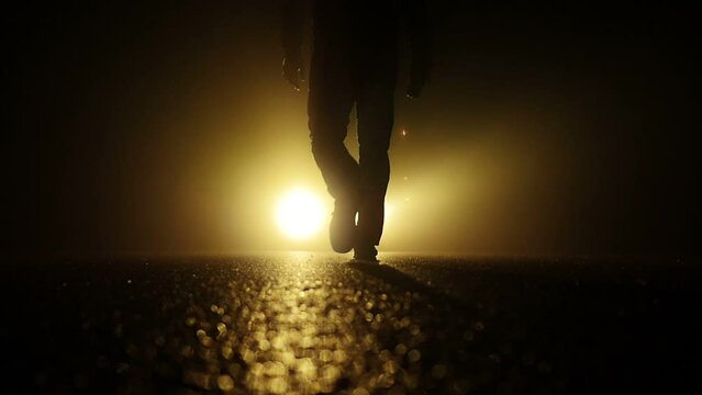 Silhouette of Spooky Scary Man Walking Steps in Mystical Darkness Scene