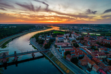 Kaunas old town, Lithuania. Aerial view of a colorful summer sunset over the city and and large inscription Lithuania with basketball on the shore