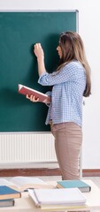 Female student in front of chalkboard