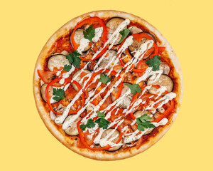 vegetarian pizza with eggplant, tomatoes, sweet peppers, mushrooms on a yellow background studio shooting © Михаил Шорохов