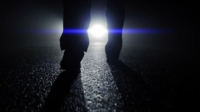 Silhouette of Man Walking in Mystical Darkness Outside at Night