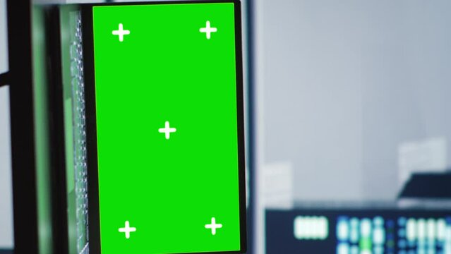 Vertical video Elderly colleagues in server hub housing high end processors capable of quickly and efficiently performing complex computations and data analysis, using chroma key laptop to fix