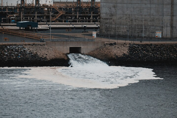 Water environment pollution. Cooling water from a nuclear reactor. Cooling water coming off from...