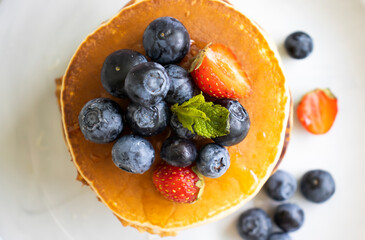 Pancakes with blueberries and strawberries