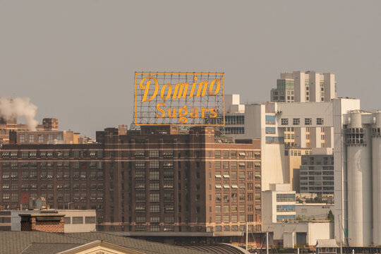 Baltimore, MD US - July 26, 2023: iconic Domino Sugars sign on top of the refining facility along Baltimore waterfront, a familiar sight to downtown residents when lit up 