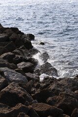 Fototapeta na wymiar Mediterranean water sea crashing to the rocks of a breakwater pier landscape