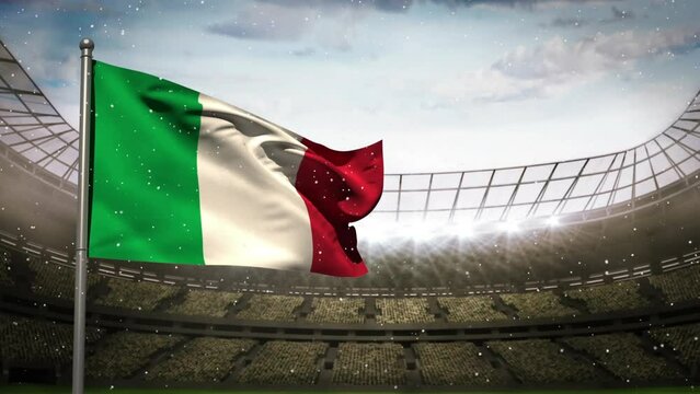 Animation of camera flashes and white particles over waving italy flag against sports stadium
