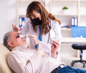 Old man visiting young female doctor for plastic surgery