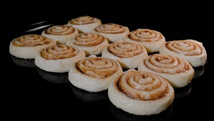 Timelapse - twelve cinnamon buns baking and rising on tray in electric oven at home. Homemade bakery, food, cooking, pastry and time lapse concept
