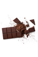 Broken organic dark chocolate bar and chocolate powder on isolated white background from above