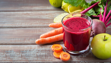 Healthy detox beetroot, carrot, apple and lemon juice smoothie in glass on wooden table, horizontal - obrazy, fototapety, plakaty