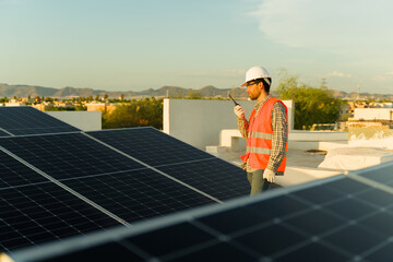 Male engineer talking about solar panels on the walkie talkie