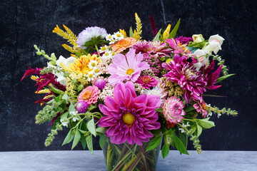 Large bouquet of flowers with a black background.