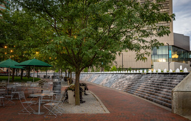 The fountain within Lexington, KY's Triangle Park takes the form of an elongated arc and features flowing water.