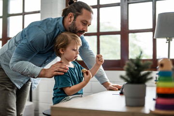 Caucasian father spend leisure time with baby boy in bedroom at house. 