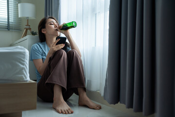 Asian young depression woman feeling heart broken and drinking beer. 