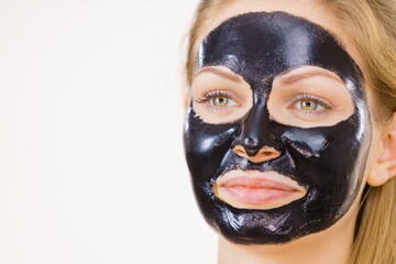 Girl black carbo peel off mask on face
