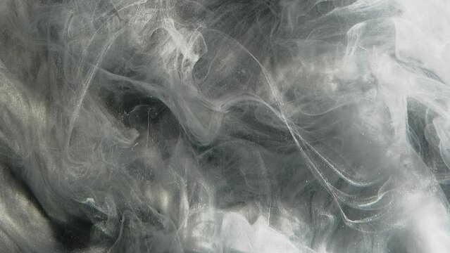 Glitter mist. Smoke texture. Magic spell. Silver gray fog cloud flow dust particles floating motion abstract art background.