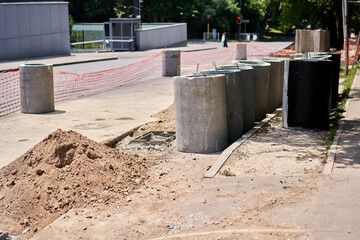 Laying concrete manholes and drain pipes for stormwater system. Connecting a trench drain to a...