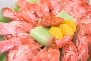 Fruit pudding with various toppings such as mint leaves, strawberries, raisins, sliced ​​almonds and chia seeds. Concept for healthy eating, fat loss, organic food, vegan diet.