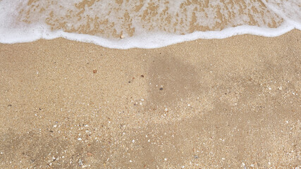 Wave of the sea on the sand beach