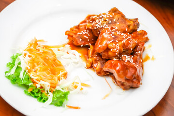 Chicken meat dish marinated and cooked in a variety of sauces served with a vegetable salad and...
