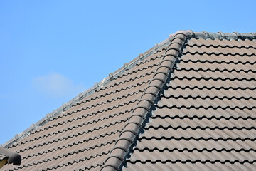 grey roof tile of house on blue sky and white cloud background